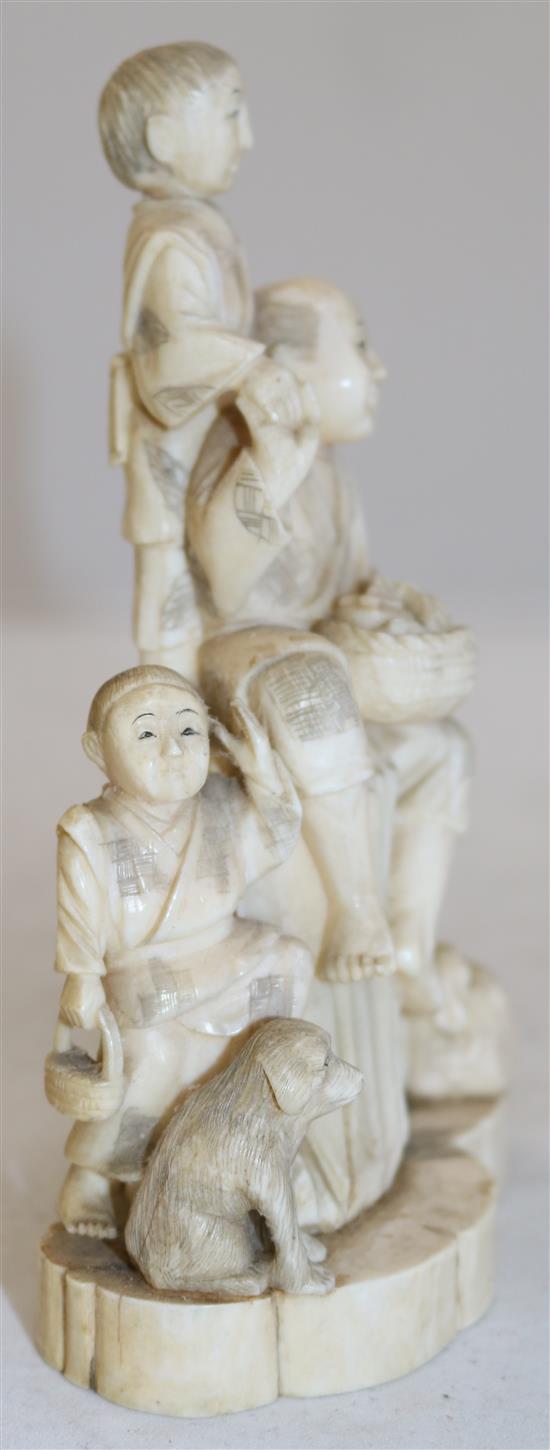 A Japanese walrus ivory okimono of a family, early 20th century, 16.8cm